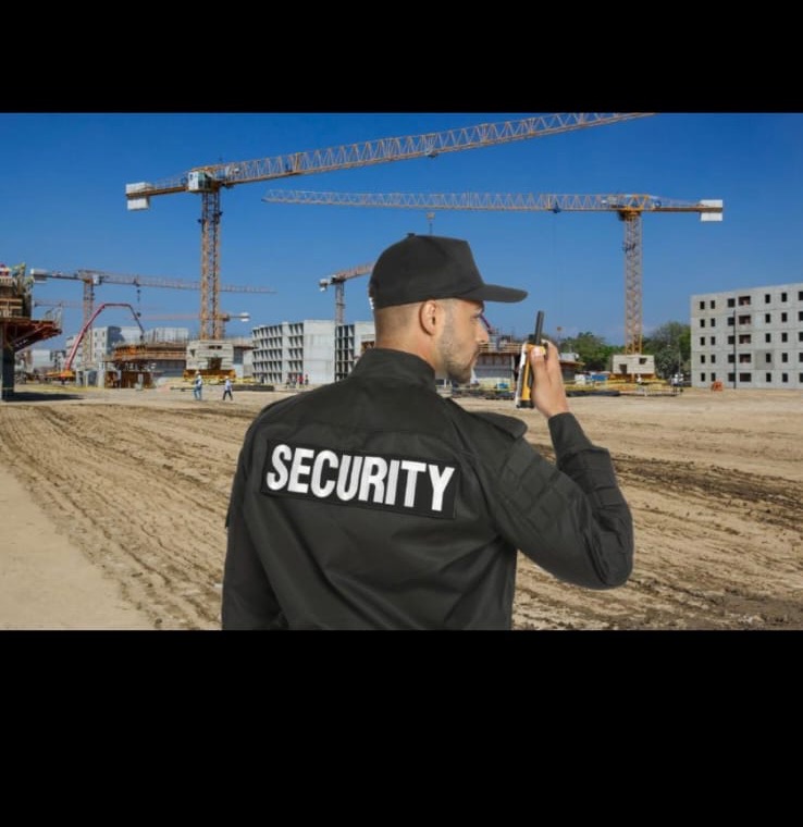 Security guard at a construction site using a radio